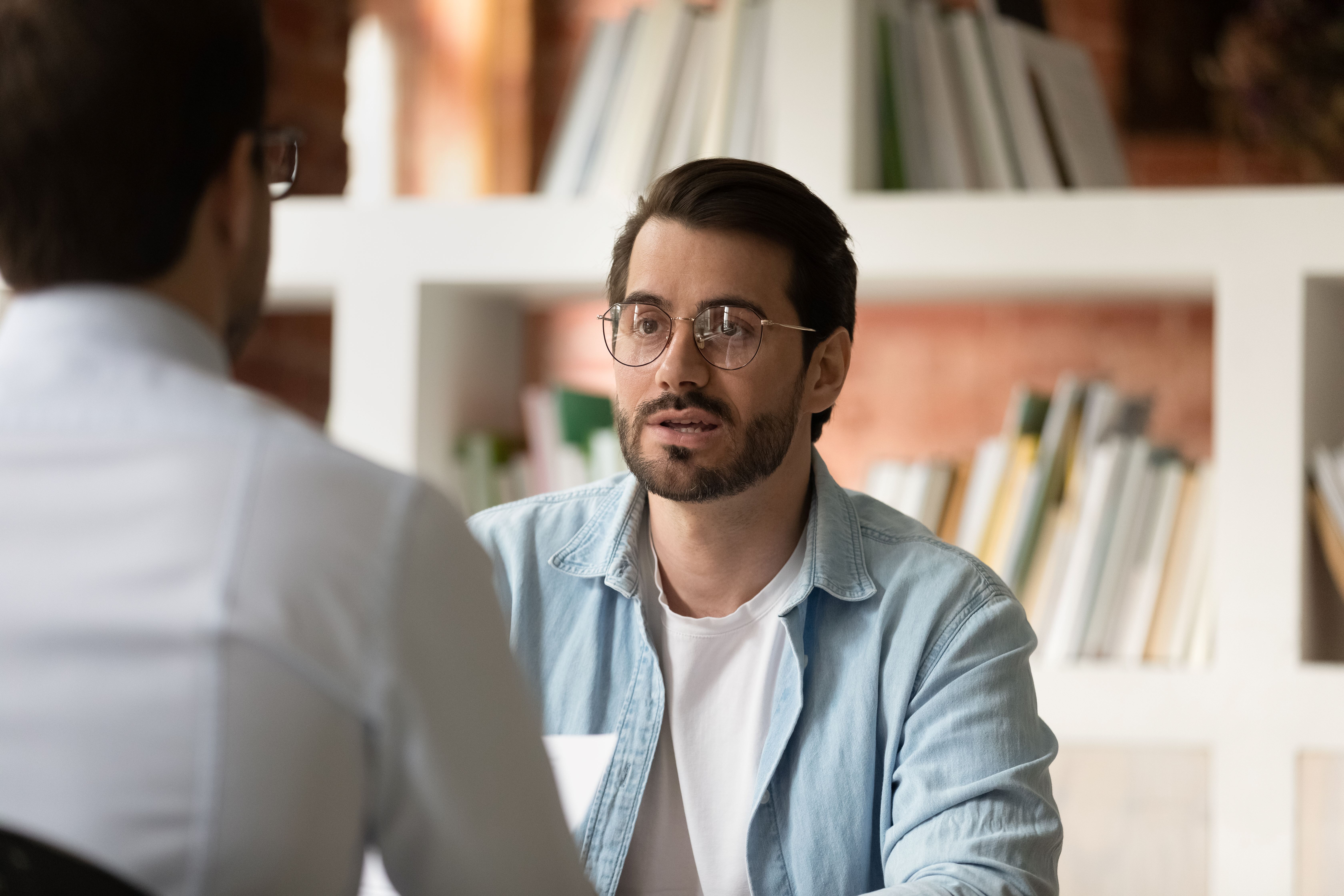 Two men talking in an office