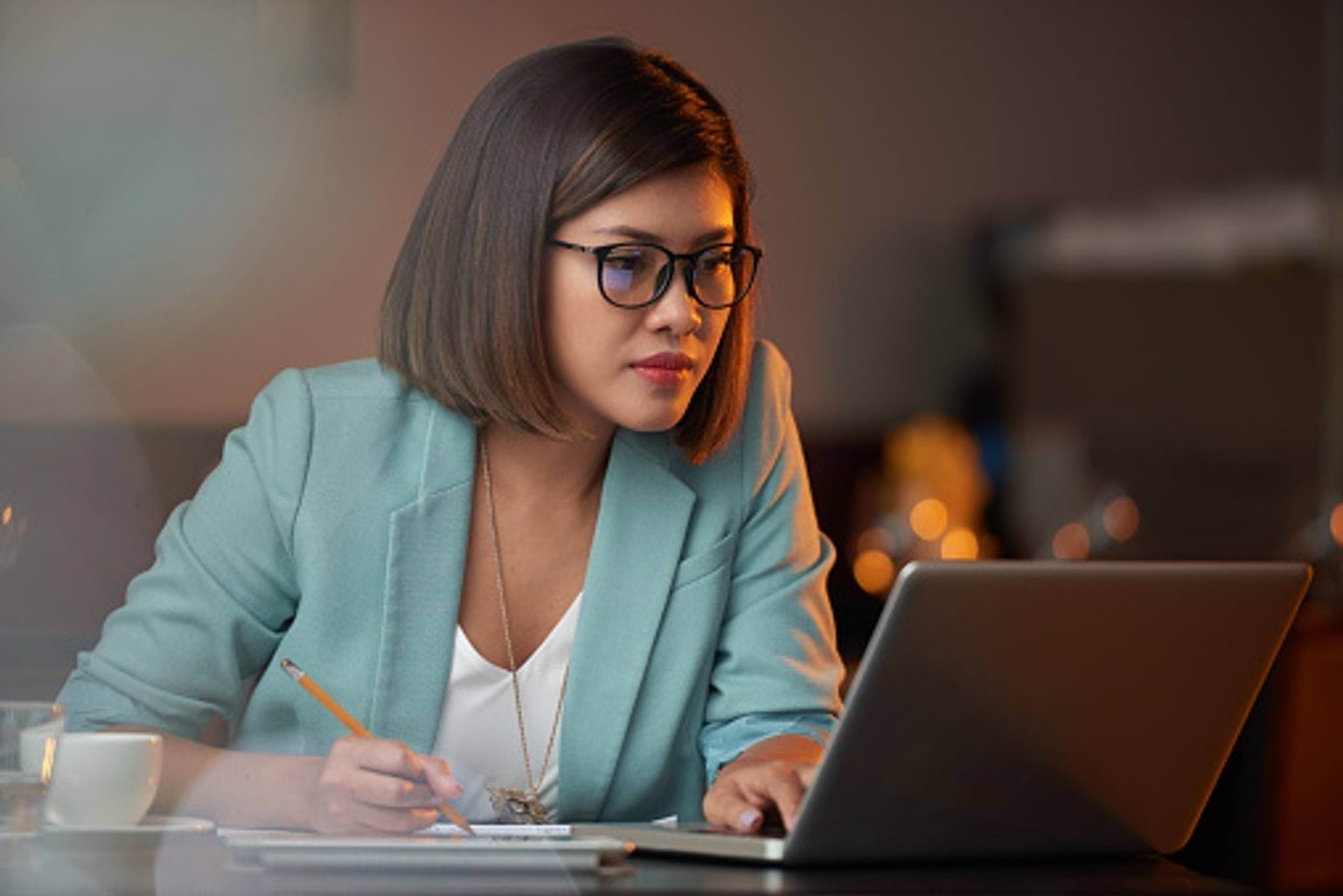 Woman with glasses with pencil and laptop Woman with glasses with pencil and laptop